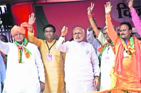 Prime Minister Narendra Modi meeting the party candidates in Rohtak district on the stage during the BJP rally on Wednesday