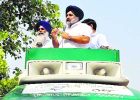 SAD president Sukhbir Singh Badal addresses public standing atop a vehicle at Kalanwali in Sirsa on Wednesday