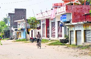 A man passes through a deserted market in Arnia town