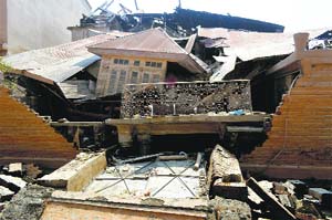 The debris of residential houses that collapsed in posh colony of Rajbagh and Jawahar Nagar in Srinagar on Wednesday.