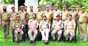 The promoted employees of the Government Railway Police pose for a photograph after the rank ceremony in Jammu on Wednesday