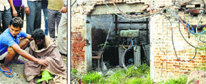 A passerby helps the woman; and (right) a transformer enclosure on Jalandhar Bypass. Photos: Inderjeet Verma
