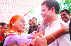 Rahul Gandhi interacts with a woman in Mahad on Wednesday. PTI