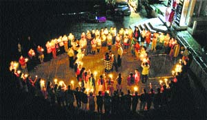 Nurses of Dronacharaya Nursing College carry candles in the shape of eye on World Sight Day in Kangra.