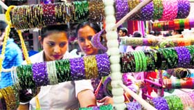 Festival shopping: Women choose bangles for Karva Chauth in Jammu on Thursday.