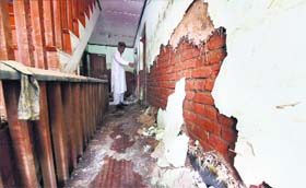 A man shows destruction inside his house caused by the recent desvastating floods at Rajbagh in Srinagar on Thursday.