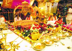 Golden glitter: A view of the Jalau (show of splendour) inside the sanctum sanctorum at the Golden Temple in Amritsar organised to mark the birth anniversary of Guru Ram Das on Thursday