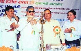 Chief Minister of Uttrakhand Harish Rawat lights a lamp at the 26th annual conclave of Uttrakhand Urja Kamgar Sangathan in Dehradun on Thursday