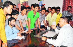 Patient hearing: DAV College students meet a social welfare officer in connection with the problems faced with coaching for the civil services examination in Dehradun on Thursday