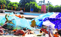 Waste material thrown near the statue of Mahatma Gandhi at the Company Bagh in Amritsar on Friday. PHOTO: RK SONI
