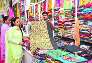 A woman chooses dress material at an exhibition in Himachal Bhawan, Sector 28, Chandigarh.
