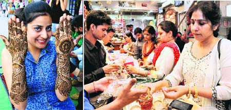(Left) A woman shows her hands decked in henna in Mohali; and women buy bangles on the eve of Karva Chauth in Sector 22, Chandigarh, on Friday.