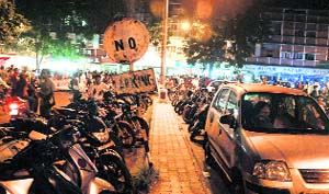 With vendors encroaching upon parking lots, vehicles parked in no-parking zones are a common sight during the festival season