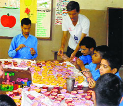 Differently abled children prepare diyas during their vocational class.