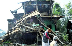 A damaged house in one of the flood-affected areas of Rajbagh in Srinagar on Friday. 