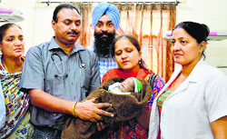 The abandoned baby girl being handed over to office-bearers of an NGO at the Civil Hospital on Friday. Photo: Inderjeet Verma