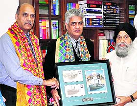 President of Komagata Maru Foundation, Canada, Harbhajan Singh Gill presents a plaque to Vice Chancellor of Punjabi University Dr Jaspal Singh in Patiala on Friday.