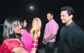 OVER THE MOON: Women perform the Karva Chauth rituals at Sukhna Lake on Saturday