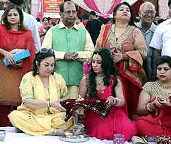 Prof Jagdish Mukhi, a senior BJP leader and MLA, along with the women celebrating the festival at Janak Puri in New Delhi on Saturday