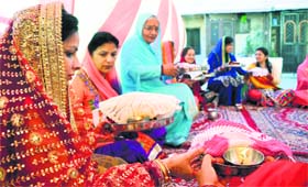 Women perform rituals during Karva Chauth in Shimla on Saturday.