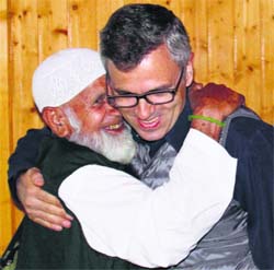 Chief Minister Omar Abdullah hugs a Haji after receiving the first batch of pilgrims on their arrival at the Srinagar Airport on Saturday.