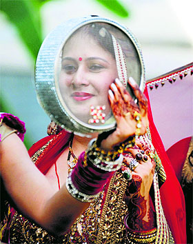 A woman performs the Karva Chauth rituals in Ludhiana on Saturday.