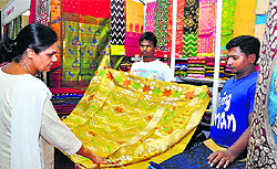 A visitor goes through the golden uppada saree costing Rs 1,15,000