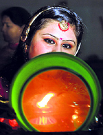 A woman performs rituals on Karva Chauth at Paanch Mandir in Jammu