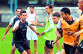 Spanish footballer Luis Garcia (2L) participates in a training session with Atletico de Kolkata teammates