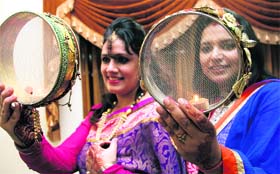 The day-long wait is over! Women perform rituals on the occasion of Karwa Chauth in Dehradun on Saturday