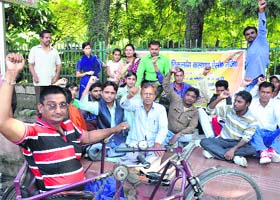 Members of the Nanda Devi Nirdhan Viklang Kalyan Association protest at Gandhi Park in Dehradun on Friday