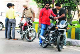 Policemen challan vehicle owners in Amritsar while the traffic on the city outskirts goes unchecked.