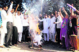 Congress workers burn an effigy of Deputy CM outside the Canal Colony police station in Bathinda on Sunday.
