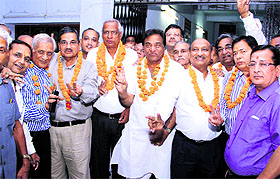 Newly elected office-bearers of the SSD Sabha flashes a victory sign in Bathinda on Sunday. 
