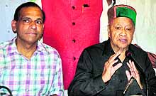 Himachal Pradesh Chief Minister Virbhadra Singh addresses a meeting in favour of the Congress candidate from Panchkula, DK Bansal (left), in Panchkula on Sunday