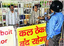 A customer buys liquor at a vend in Panchkula