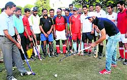 Sardar Singh, captain of the Indian hockey team, gives tips to members of the Chandigarh Police team during a practice session in Chandigarh on Sunday