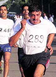 Constable Ramesh Kumar of the IRB leads the Chandigarh Half Marathon 2014 at Sukhna Lake on Sunday