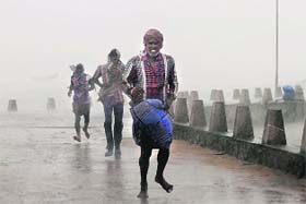People caught in heavy rain at Gopalpur in Odisha