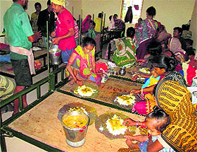 Volunteers serve food villagers who moved to cyclone shelters in Gopalpur. 