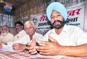 Members of the Shail Shikhar organisation address mediapersons in Dehradun on Sunday
