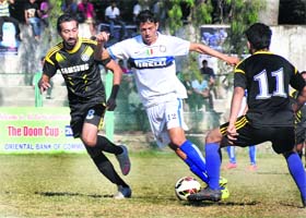 Players of Northern Railway and Uttarakhand Police battle for the ball during a match in the Narendra Singh Kharola Memorial Football Tournament at Pavilion Ground in Dehradun on Sunday