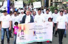 People take part in a walkathon organised by Max Super Speciality Hospital on the occasion of World Arthritis Day in Dehradun on Sunday