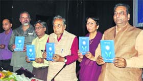 Mayor Vinod Chamoli and noted author Dr Sher Jung Garg release a poetry book written by Dolly Dabral at Town Hall in Dehradun on Sunday
