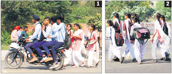 1) Four schoolgoing students ride a motorbike, violating norms, as auto-rickshaws were off the roads on a strike call given by the Amritsar Auto-Rickshaw Union 2) students walk to their school