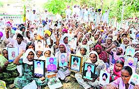 Members of the Bharatiya Kisan Union (Ekta Ugrahan) display photographs of the farmers, who have committed suicide, raise slogans outisde the District Administrative Complex in Bathinda on Monday. 