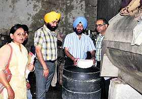 Health officials destroy cheese at Jagatpura village in Mohali. 