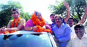 Punjabi singer Jasbir Jassi with Shakti Rani Sharma, HJC-HJCP candidate from Kalka, during a road show in Pinjore on Monday. 