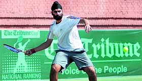 Brahmjot Singh in action during a match at the CLTA courts in Sector 10, Chandigarh, on Monday. 