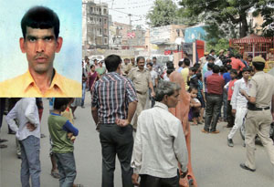 People gather outside the police station as a Delhi Police constable Jagbir (inset) was killed and another injured when some persons opened fire on them in Vijay Vihar on Monday.